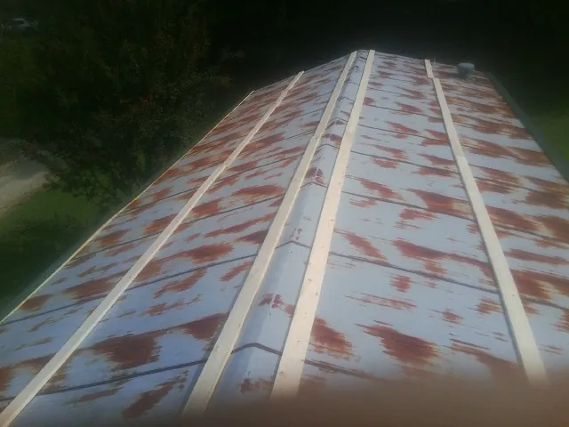 Rusted metal roof panels with new wood purlins before replacement — Storm Damage Roof Repair in Southbury by Roofing Brothers