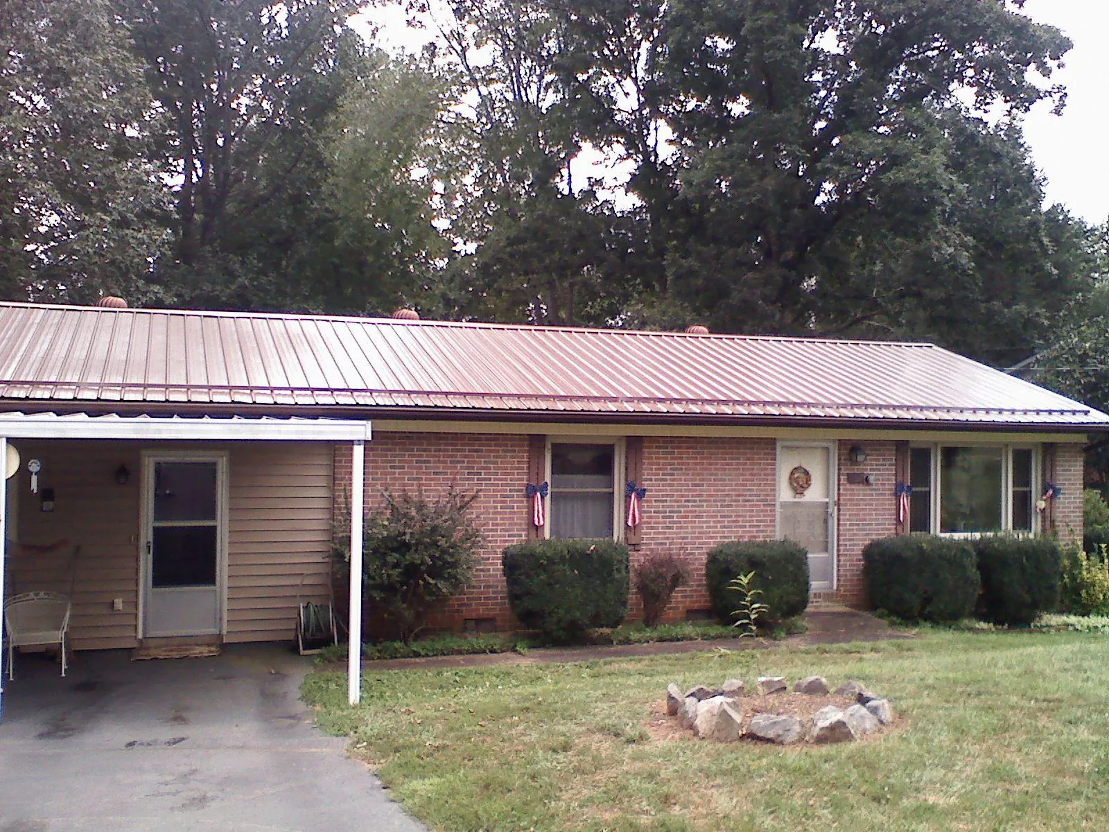 Bronze metal roof and carport on a brick ranch home — Roof Repair work by our crew in Southbury