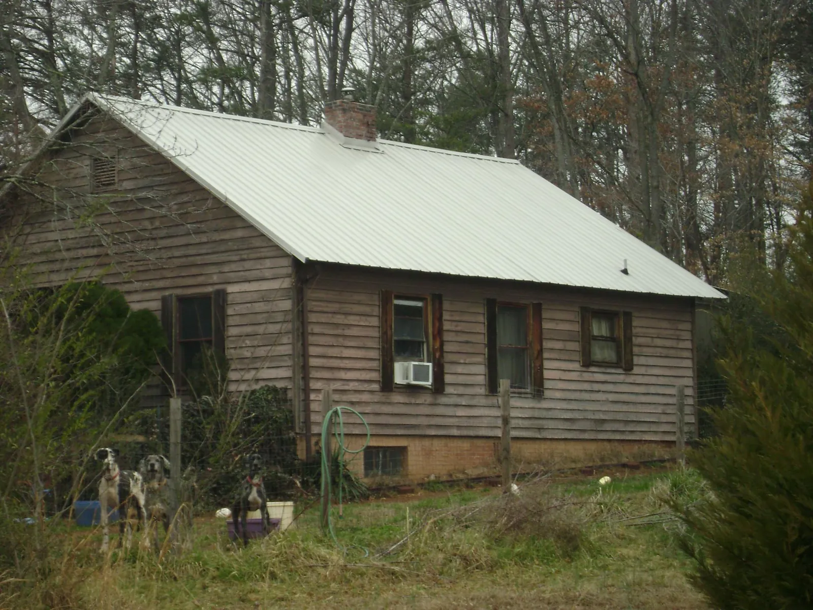White metal roof on an old wood sided farmhouse, from a Metal Roof Installation job in Southbury